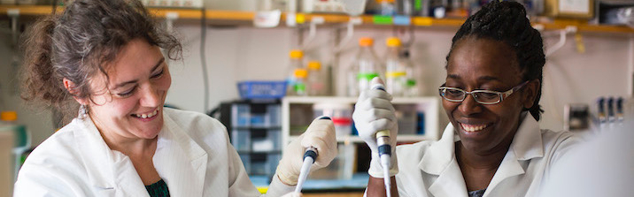 Two women working with lab equipment